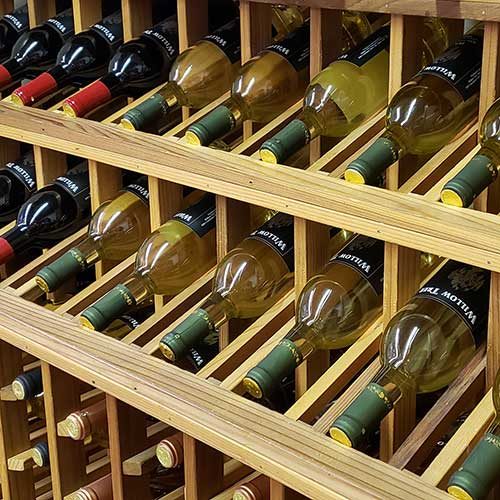 Bottles of wine in rack from right side.