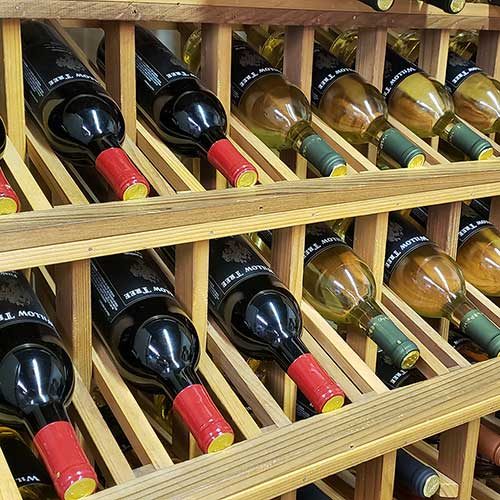 Bottles of wine in rack from left side.